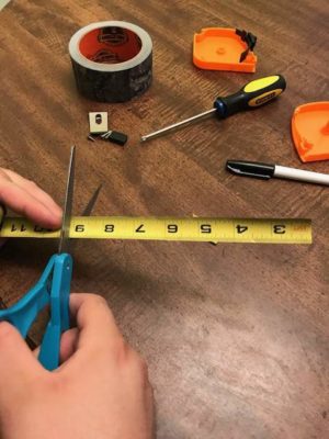 scissors cutting the measuring tape