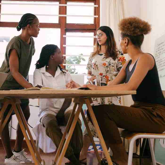 A woman gathered at the table having a discussion together.