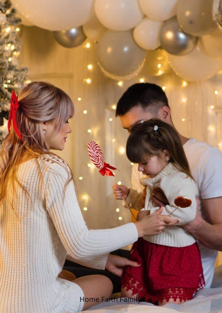 A young couple holding onto their daughter. This family is surrounded by Christmas decorations.