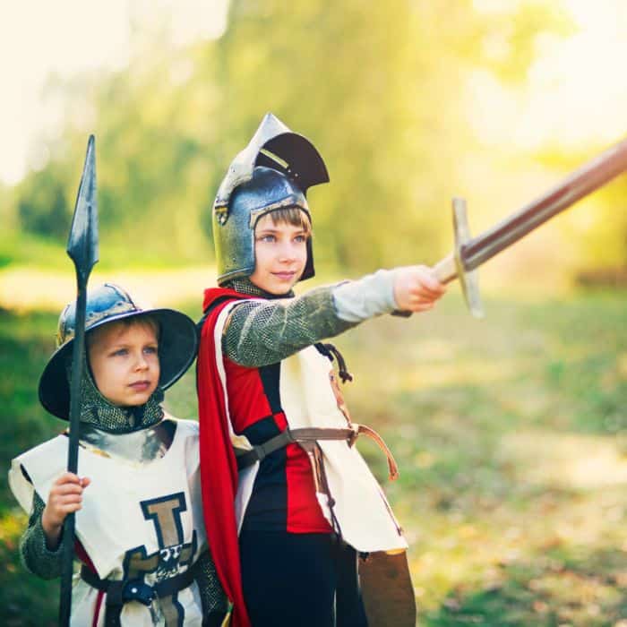 Two boys dressed as knights.