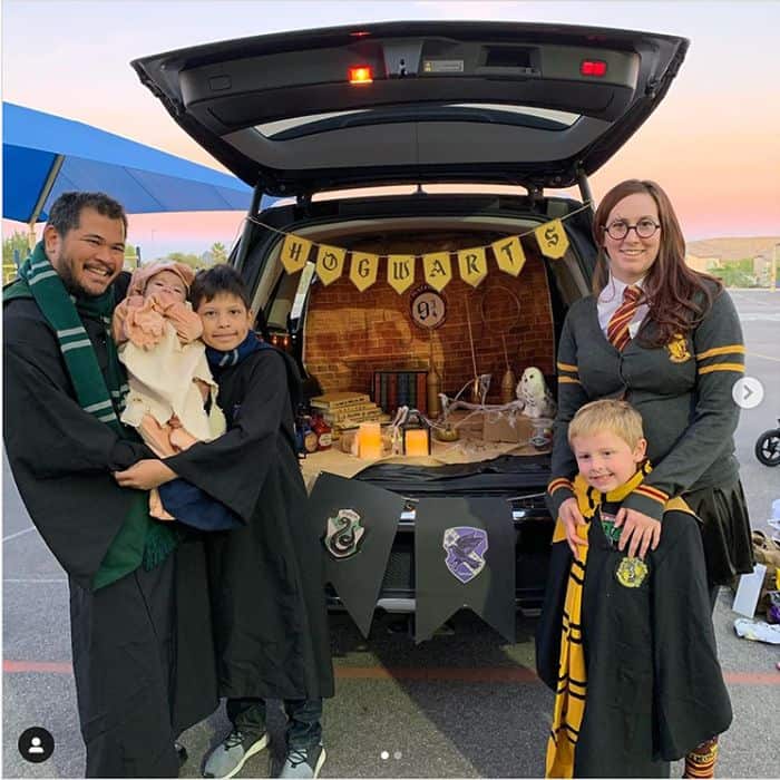 A family with a Harry Potter theme trunk or treat decorations