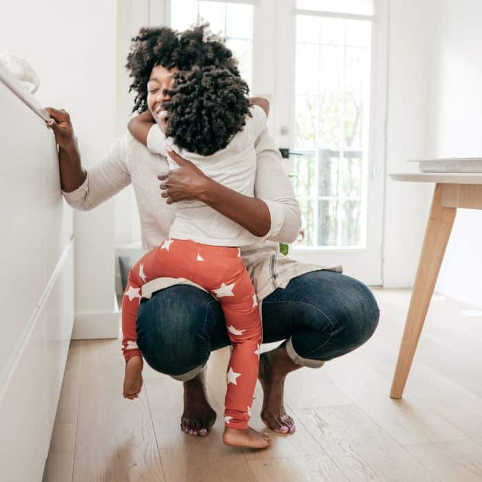 A mother holding her child in her arms.