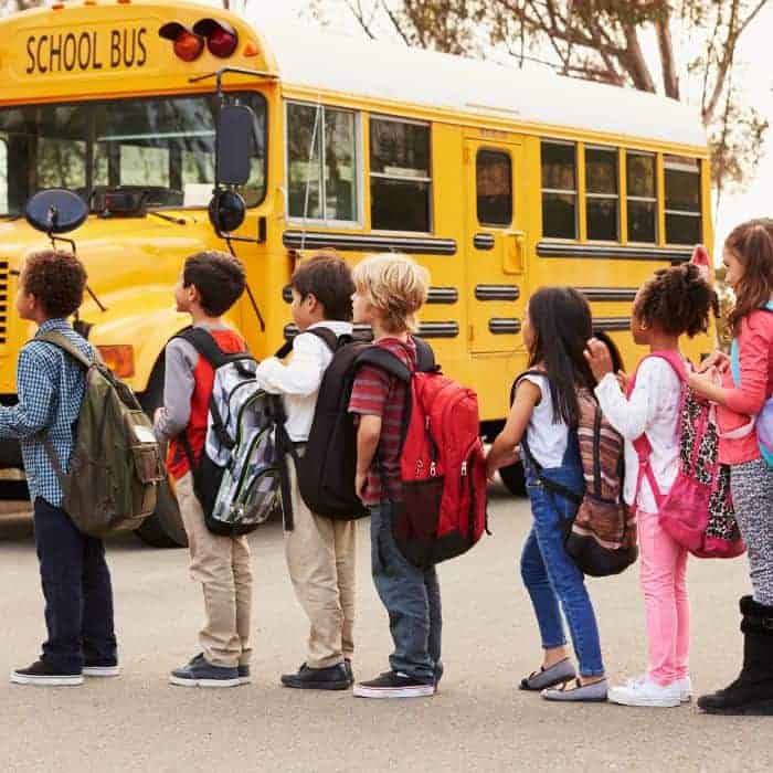 Public school students line up to ride home on the public school bus.