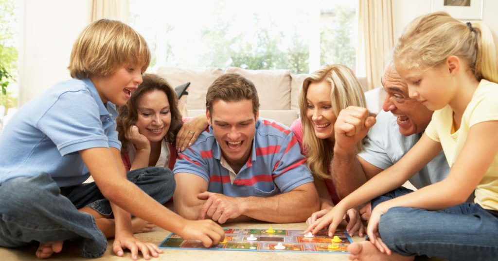 A family getting together playing board games.