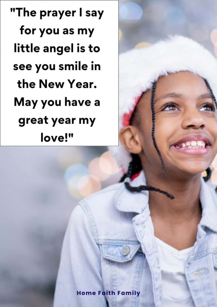 A little girl wearing a Santa hat and smiling.