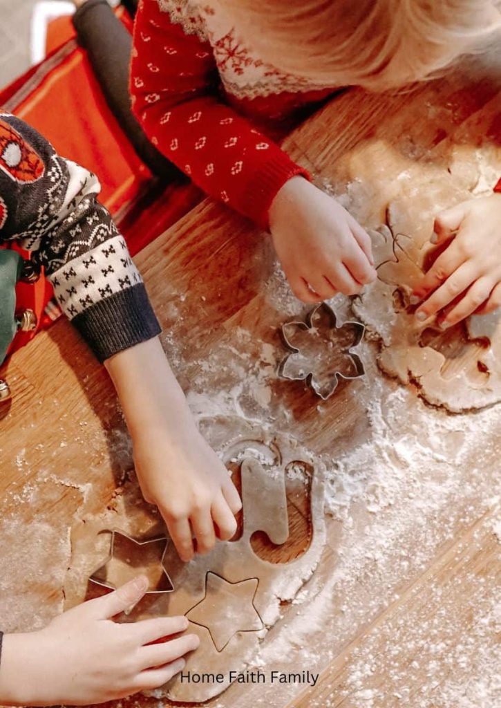 Two children baking Christmas cookies.