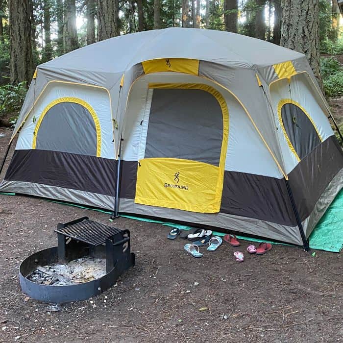 A Browning 8-person Big Horn tent with children's flip flops outside.