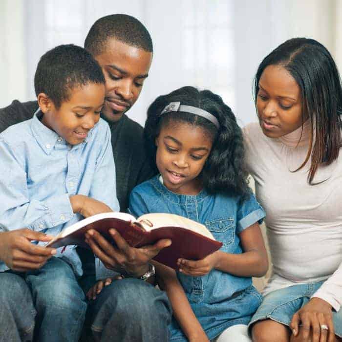 A family praying and reading the scriptures together.
