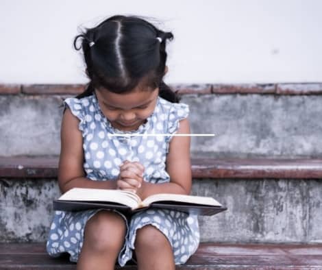 A child reading the Bible.