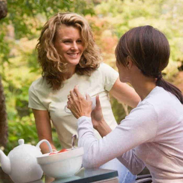 Two women showing Christian hospitality.