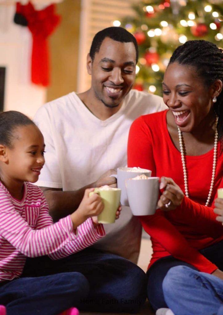 A family drinking hot chocolate together at Christmas time.