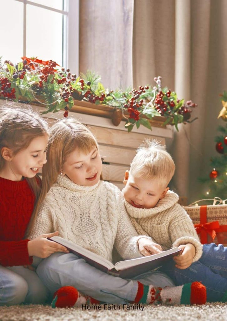 Three children sitting on the floor next to a Christmas tree to read a book.