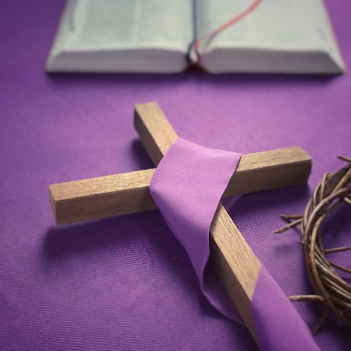 A wooden cross wrapped in purple cloth for Good Friday.
