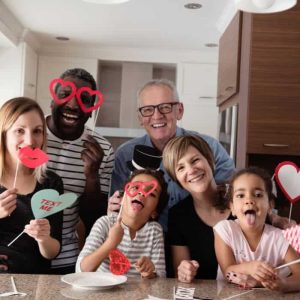 A family with grandparents, parents, and children surrounded by Valentine's day products.
