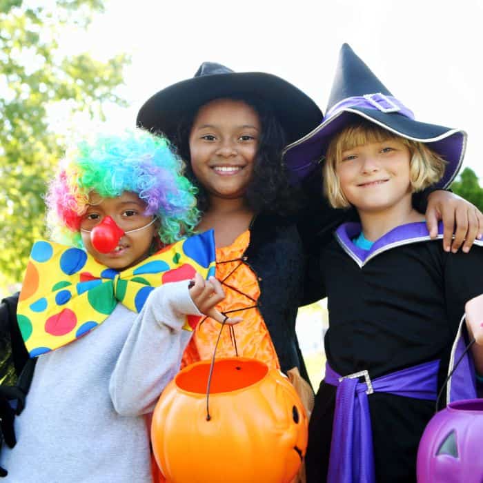 A small group of young children dressed up for Halloween.