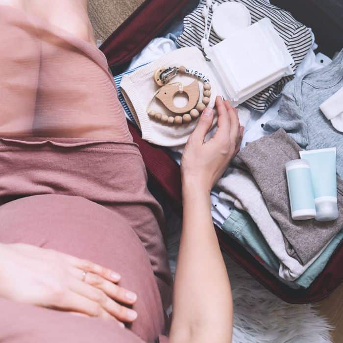 A pregnant woman packing a hospital bag.