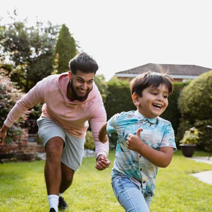 happy fathers day to the best uncle; an uncle chasing his nephew around the yard.