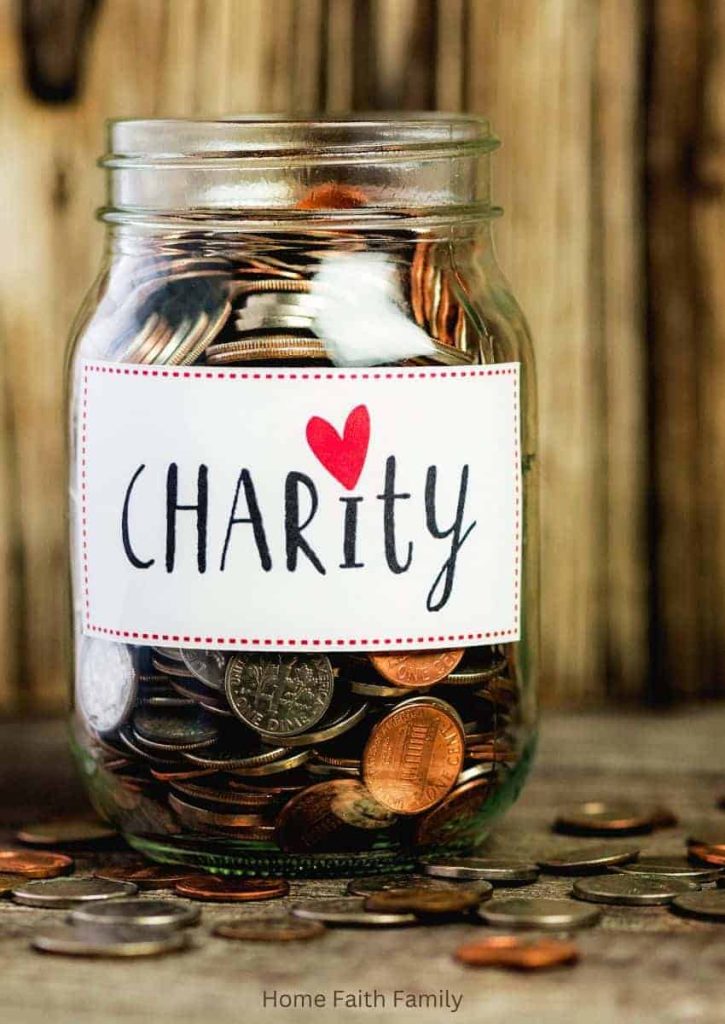 A coin jar with a sign that reads "charity". The jar is full of spare change.