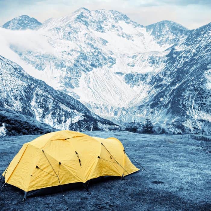 A tunnel tent on the base camp of a mountain.