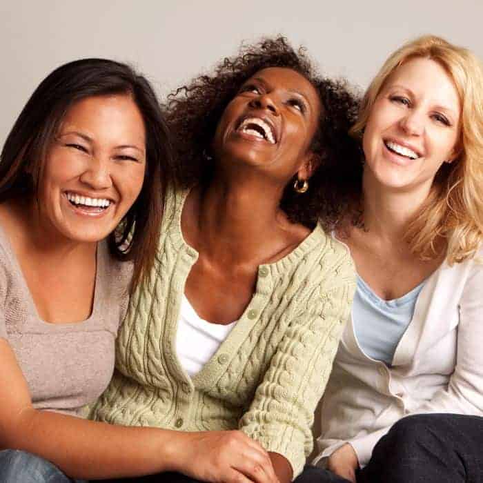 A group of women of different diversities laughing and celebrating together.