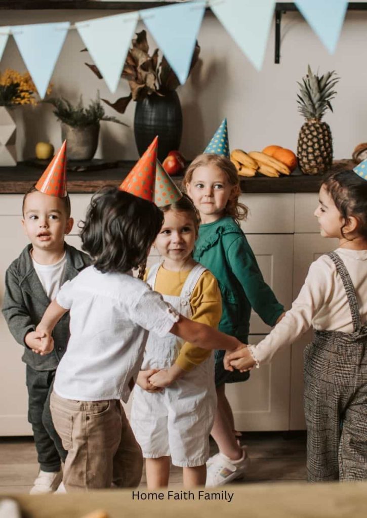 A group of children wearing party hats and holding hands.