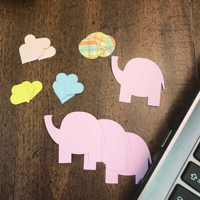 Pink paper elephants and colorful paper hearts.