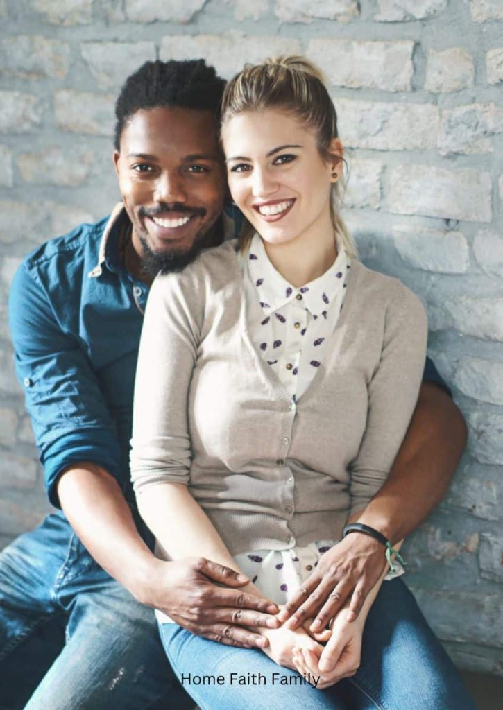 A biracial couple sitting next to each other.