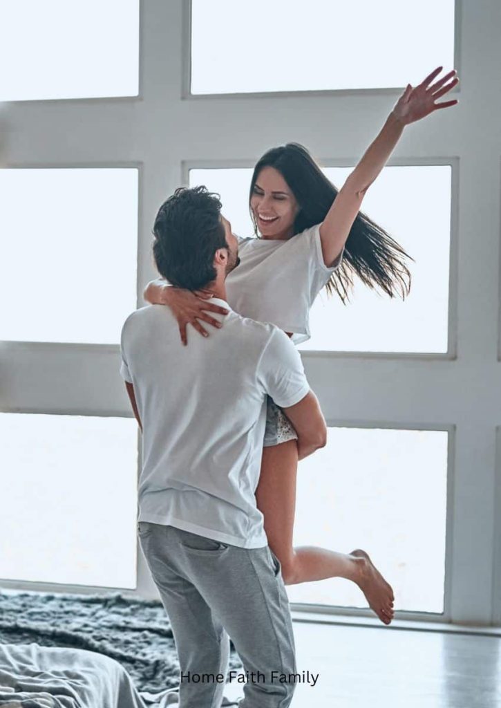 A woman jumping into her husband's arms.