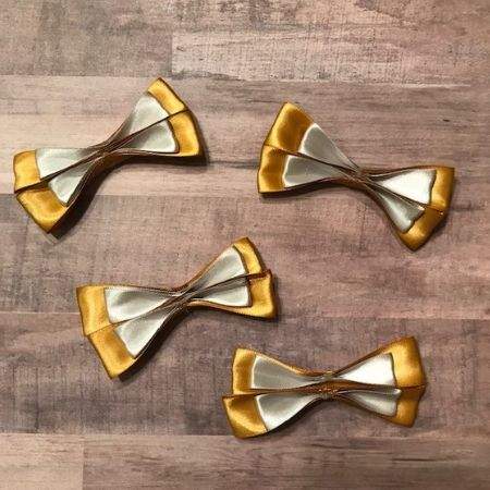 Silver and gold bows pinched together.